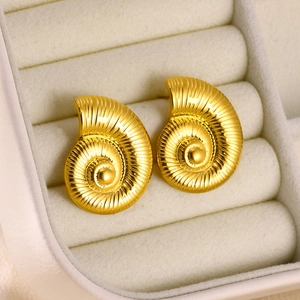 Macro shot of gold-plated stainless steel nautilus shell earrings in a velvet gift box