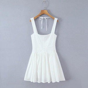 Detail of white mini dress with square neckline and criss-cross lace-up back design