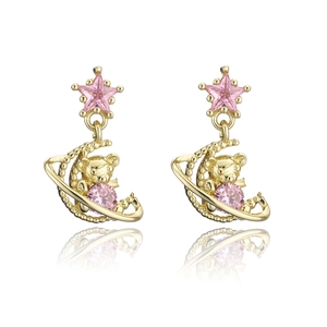 Detail of gold moon and bear earrings with pink star and round zircon stones