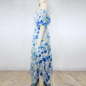 Detail of blue and white abstract print on a tiered off-shoulder maxi vacation dress