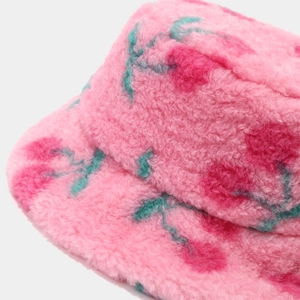 Close-up of pink plush bucket hat featuring floral print and soft faux fur texture