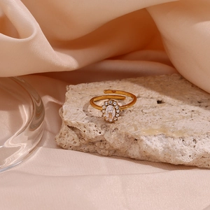 Detail of 18K gold plated adjustable ring featuring an oval zircon set on a stone