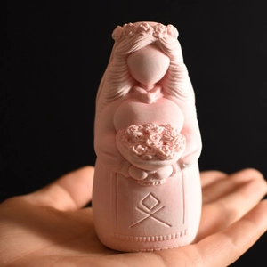 Macro shot of a pink 3D goddess candle mold showing intricate floral textures and finish