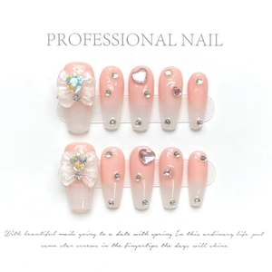 Detail of handmade coffee ombre coffin nails with crystal bow and rhinestones