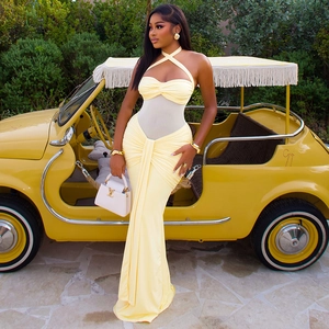 Detailed view of yellow backless maxi dress with sheer mesh paneling and ruched details