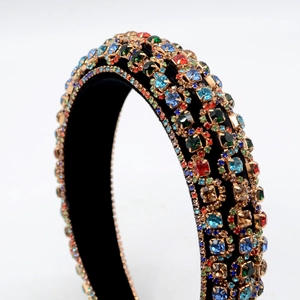 Close-up of luxury velvet headband with colorful rhinestones in gold settings
