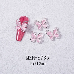 Detail of 15x13mm cat eye stone butterfly nail charm with 3D silver metal frame on red nail