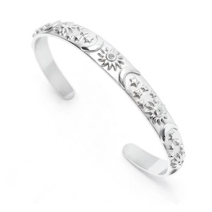 Macro detail of silver sun and moon embossed bangle with inlaid zircon stones