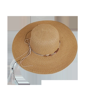 Khaki wide brim straw sun hat with beaded ribbon and bow detail in a top-down view