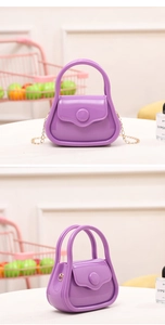 Detail of purple mini jelly bag showing glossy PVC texture and golden chain strap