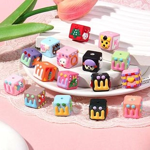 Close-up of colorful acrylic cat paw and animal pattern cube beads for DIY jewelry making