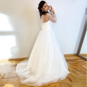 Robe de mariée élégante blanche avec manches bouffantes en perles et jupe en tulle évasée