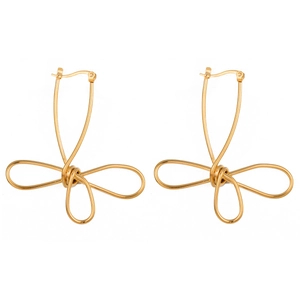 Close-up of golden abstract bow-shaped earrings with polished metal finish and hoop closure