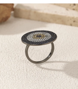 Macro view of black silver ring featuring a sparkling blue evil eye pave setting design