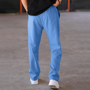 Back view of men's loose fit casual athletic pants in sky blue fabric shown on model
