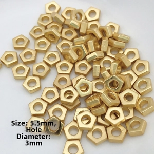 Macro detail of 5.5mm gold pentagon spacer beads for DIY jewelry making and crafting