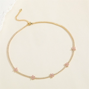 Detail of tennis choker with white zircons and pink floral charms in gold plating