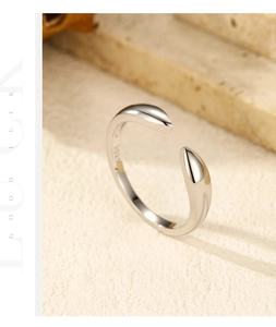 Close-up of S925 sterling silver minimalist open ring with teardrop ends on stone
