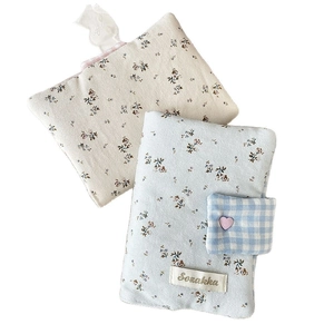 Floral fabric book cover with heart buckle and strap in blue and cream colors