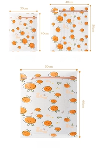 Detailed set of three fine mesh laundry bags with orange fruit prints in various sizes