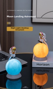 Close-up of floating astronaut moon lamp with 3D printed surface and LED lighting