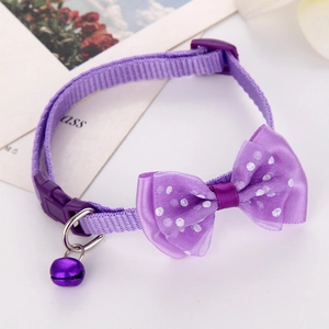 Close-up of purple polka dot bow pet collar with matching bell and plastic buckle