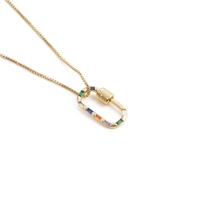 Close-up of gold carabiner pendant with colorful rectangular stones on box chain