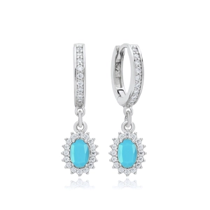 Macro shot of silver drop earrings with oval sky blue gemstones and zircon halo detail