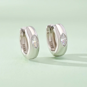 Polished S925 sterling silver hoop earrings with marquise-cut zircon on light green backdrop