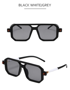 Detail of square sunglasses with dual-tone black and white temples and gold metal accents