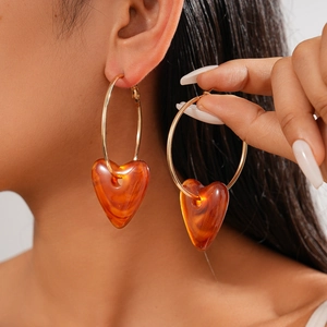 Minimalist gold hoop earrings with oversized amber acrylic heart pendants for women