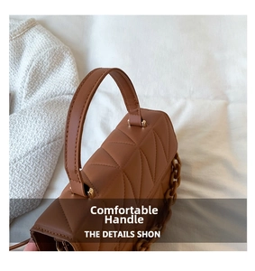 Vue détaillée de la poignée du sac matelassé marron et de la grosse chaîne en plastique