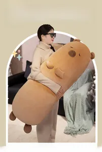 Extra long capybara plush pillow being held by a model to show its large size