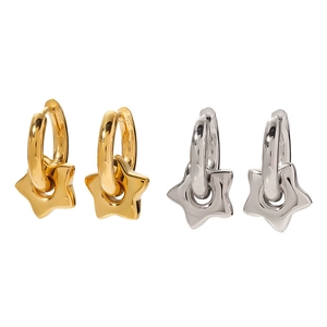 Detail view of 18k gold and silver stainless steel hoop earrings with star pendants