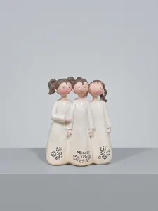 Detail of three resin sisters figurines featuring Big Sis, Middle Sis and Lil Sis inscriptions