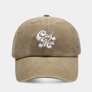 Close-up of the white Cool Mom embroidery on a vintage washed khaki baseball cap