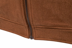 Detailed macro view of the brown suede jacket hem and sturdy metal zipper closure