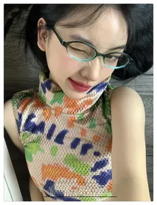 Detail view of teal translucent oval glasses frames on a model for a vintage aesthetic