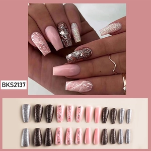 Macro detail of long coffin press-on nails with pink marble, silver foil and glitter finish