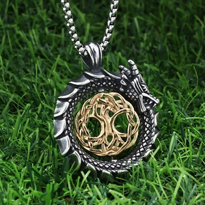 Detail view of Ouroboros dragon pendant with Tree of Life in antique silver and gold finish