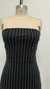 Close-up of vertical silver rhinestones on a black strapless bodycon mini dress