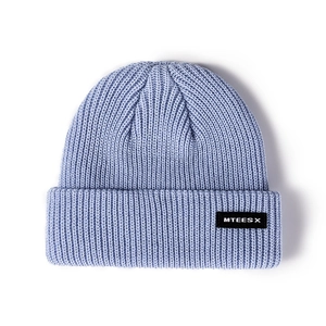 Light purple knitted beanie hat with stylish letter patch on a clean white background