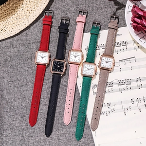 Detail of square quartz watches with colorful suede straps and elegant rose gold frames