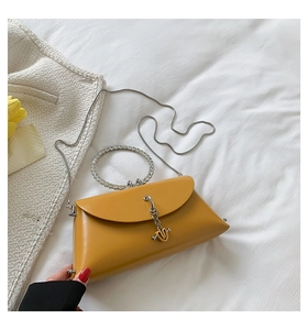 Detail of yellow jelly shoulder bag with rhinestone ring handle and metal chain strap