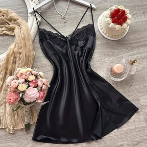 Elegant black satin lace slip dress displayed with romantic accessories on wooden floor