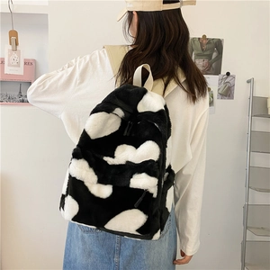 Cow print plush backpack with soft faux fur texture and adjustable straps for women