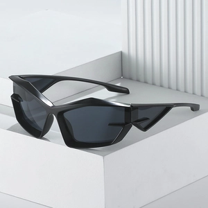 Futuristic black cat eye sunglasses with geometric frames on a white marble platform