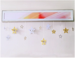 Detail of hollow and solid gold and silver hanging star decorations for holiday parties