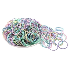 Colorful elastic hair ties for girls in a white bowl with soft pastel colors display