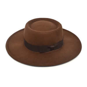 Detail of a brown wool felt fedora featuring a wide brim and decorative grosgrain bow